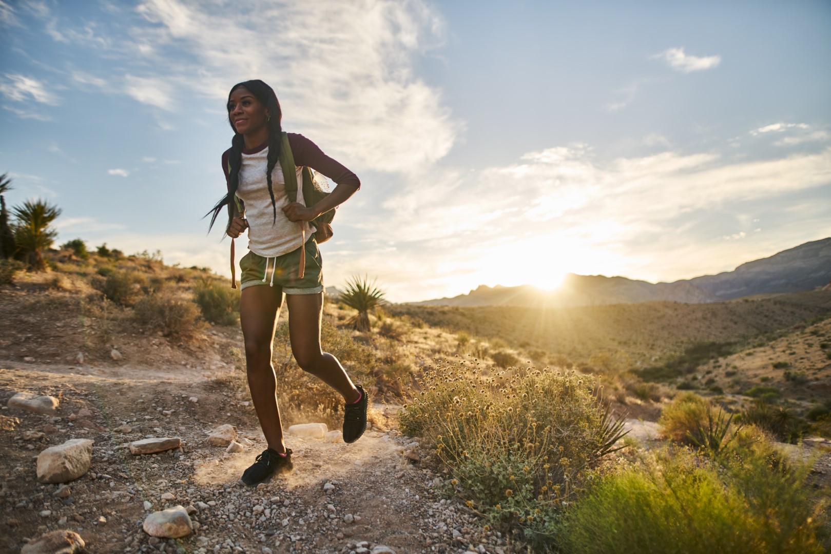 Jogger on desert trail at sunrise near Red Rock RV Resort in Las Vegas, NV.
